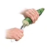 Hands using a zucchini corer to hollow out a zucchini. Voir les images du produit