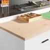 A close-up view of a white storage cabinet with a wooden top, showing a wooden organizer tray with compartments on top. Produktbild-Vorschau