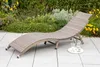 A lounge chair on a patio with plants in the background. Produktbild-Vorschau