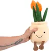A hand is holding a plush toy of a potted tulip plant. Produktbild-Vorschau