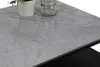A close-up view of a marble-patterned tabletop with a potted plant and a jar of pebbles on it. Produktbild-Vorschau