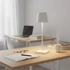 A desk with a laptop, books, a lamp, and a cup of coffee. Náhled obrázku produktu