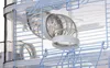 A close-up view of a clear plastic tube connector with white ends, attached to a blue wire cage. Anteprima dell’immagine prodotto