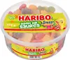 A clear, well-lit studio shot of a large, clear plastic tub filled with colorful gummy candies, with a prominent branded label. Podgląd zdjęcia produktu