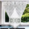 A decorative window curtain hanging in front of a window with greenery visible outside. Podgląd zdjęcia produktu