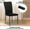 A black chair with a diamond-stitched backrest and metal legs, displayed in a room with curtains. Produktbild-Vorschau
