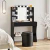 A black vanity table with LED lights and a mirror, set up in a bedroom next to a bed. Produktbild-Vorschau