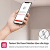 A hand holds a smartphone displaying a device test app, with a smoke detector visible on the ceiling in the background. Produktbild-Vorschau
