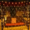 A swing set with a net of warm white lights draped over it, with a decorative pillow on the seat. Produktbild-Vorschau