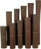 A collection of rolled-up willow screens of varying heights arranged in a staggered row against a white background. Produktbild-Vorschau
