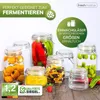 A collection of glass jars filled with various preserved foods, including peppers, fruits, and olives, arranged on a wooden surface. Produktbild-Vorschau