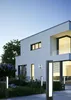A modern white house with outdoor lighting at dusk. Anteprima dell’immagine prodotto