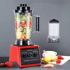 A red blender filled with fruits and vegetables is shown on a gray background, with a spare blender cup to the right. Some fruits are also visible in the foreground. Produktbild-Vorschau