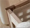 A close-up view of the corner of a wooden laundry basket with a linen sack inside and a white towel at the bottom. Náhled obrázku produktu