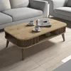A coffee table with two cups of coffee and a newspaper on it, placed in a living room setting with a sofa. Anteprima dell’immagine prodotto