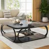 A living room scene featuring a coffee table with items on it, a sofa, and a plant. Podgląd zdjęcia produktu