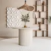 A dining table set in a room with a bookshelf and wall art. Produktbild-Vorschau