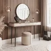 A vanity table with a mirror, stool, and accessories in a well-decorated room. Produktbild-Vorschau