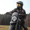 A person on a motorcycle in an outdoor setting. Produktbild-Vorschau