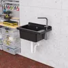 A utility sink and storage bins in a workshop or garage setting. Produktbild-Vorschau