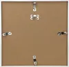 The back of a white picture frame with a brown cardboard insert and metal clips. Produktbild-Vorschau