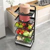 A multi-tiered kitchen cart filled with fruits, vegetables, and cooking pots, placed on a kitchen floor next to a countertop. Produktbild-Vorschau