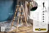 A wooden ladder is set up indoors, possibly during a painting or renovation project, with protective plastic sheeting on the floor and walls. Produktbild-Vorschau
