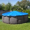 An above-ground swimming pool covered with a blue tarp, situated in a grassy backyard with trees and a brick wall in the background. Produktbild-Vorschau