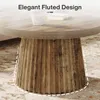 Close-up of a round coffee table with a fluted base, showing its wood-like texture and design. Anteprima dell’immagine prodotto