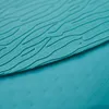 A close-up view of the textured surface of a teal paddleboard. Produktbild-Vorschau