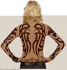 A woman from behind wearing a long-sleeved shirt with tribal tattoo print. Produktbild-Vorschau