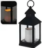 A black metal lantern with a white LED candle inside, shown on a white background. A close-up inset shows the lit candle. Náhled obrázku produktu
