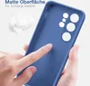 A hand is touching a blue phone case, highlighting its matte surface and soft grip. Produktbild-Vorschau