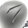 A close-up view of the top of a black helmet, showing ventilation details. Náhled obrázku produktu