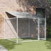 A dog kennel with a roof and door, set up on artificial grass next to a brick wall. Produktbild-Vorschau