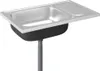 A stainless steel sink with a black basin and a ribbed draining board, shown from a slightly elevated front-left angle. A flexible grey drain pipe extends downwards from the basin. Voir les images du produit