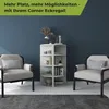 A corner bookshelf is placed between two armchairs in a room with a dark blue wall and a gray rug. Produktbild-Vorschau