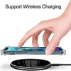A hand is placing a transparent phone case with a phone inside onto a wireless charger. Produktbild-Vorschau