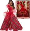 A Barbie doll wearing a red plaid holiday dress, shown both out of its box and in its packaging. Náhľad obrázku produktu