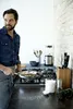 A man is cooking in a modern kitchen. Podgląd zdjęcia produktu
