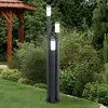A garden setting with a gazebo and lush greenery, featuring a modern outdoor lamp post. Produktbild-Vorschau