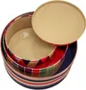 A set of three round tin containers with patterned exteriors and plain beige interiors, with one lid placed on top. Produktbild-Vorschau