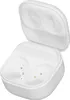An open white charging case for earbuds, showing the interior compartments for the earbuds and charging pins. Podgląd zdjęcia produktu