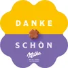 A decorative marketing image for Milka chocolates, featuring the words 'Danke Schön' and a small chocolate flower. Produktbild-Vorschau