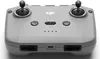 A top-down view of a gray DJI remote controller with black joysticks and buttons, set against a white background. Podgląd zdjęcia produktu