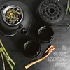 A tea set laid out on a dark surface, with tea leaves in the teapot and bamboo stalks. Produktbild-Vorschau