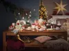 A Christmas-themed table setting with festive decorations and tableware. Produktbild-Vorschau