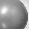 A close-up view of a gray pilates ball with a bright light reflection. Produktbild-Vorschau