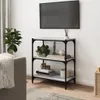 A living room scene with a TV mounted on the wall above a bookshelf. Produktbild-Vorschau