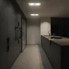 A modern, dark kitchen with built-in appliances and a kitchen island. Produktbild-Vorschau